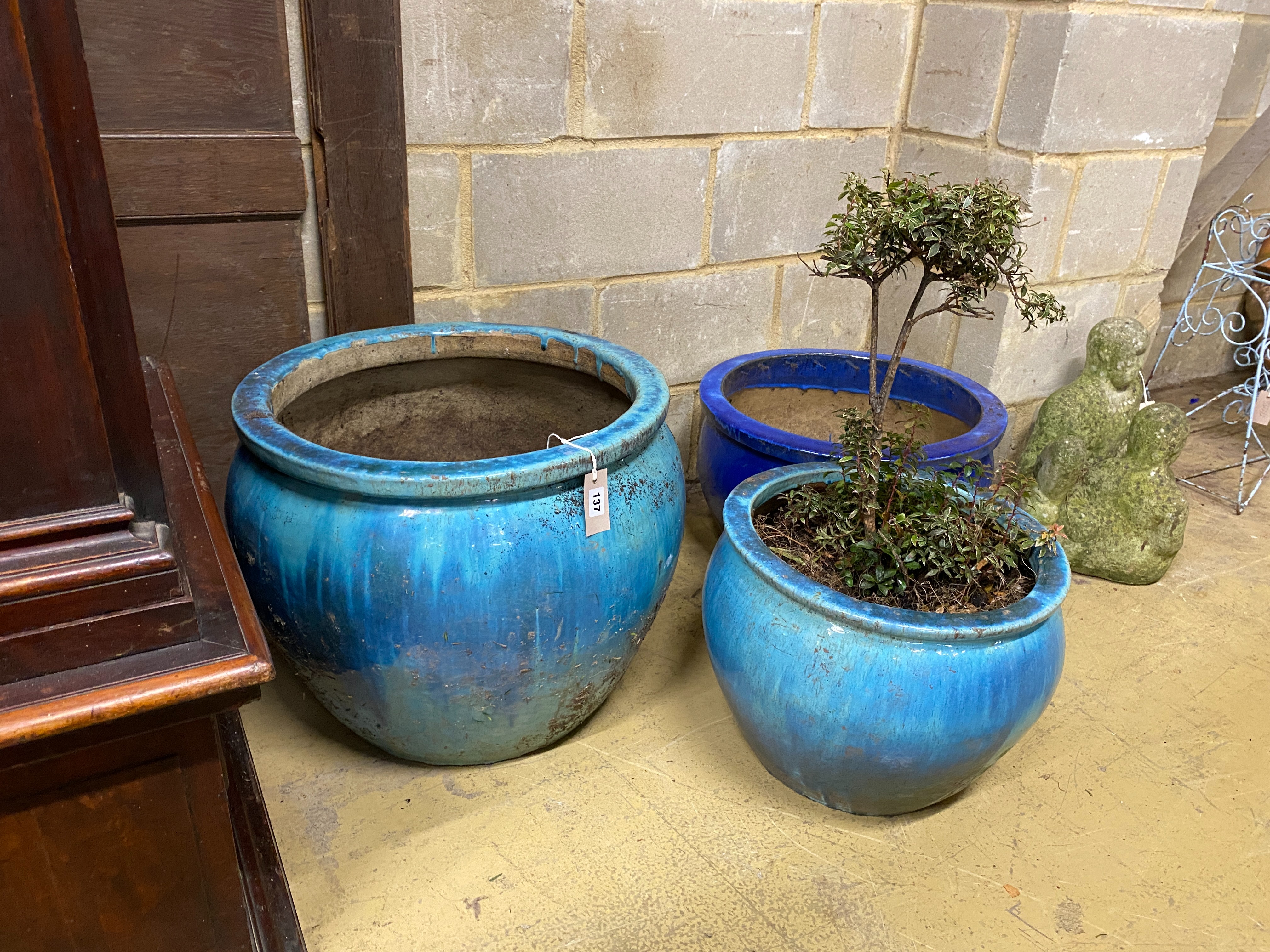 Three circular glazed earthenware garden planters, largest diameter 54cm, height 46cm